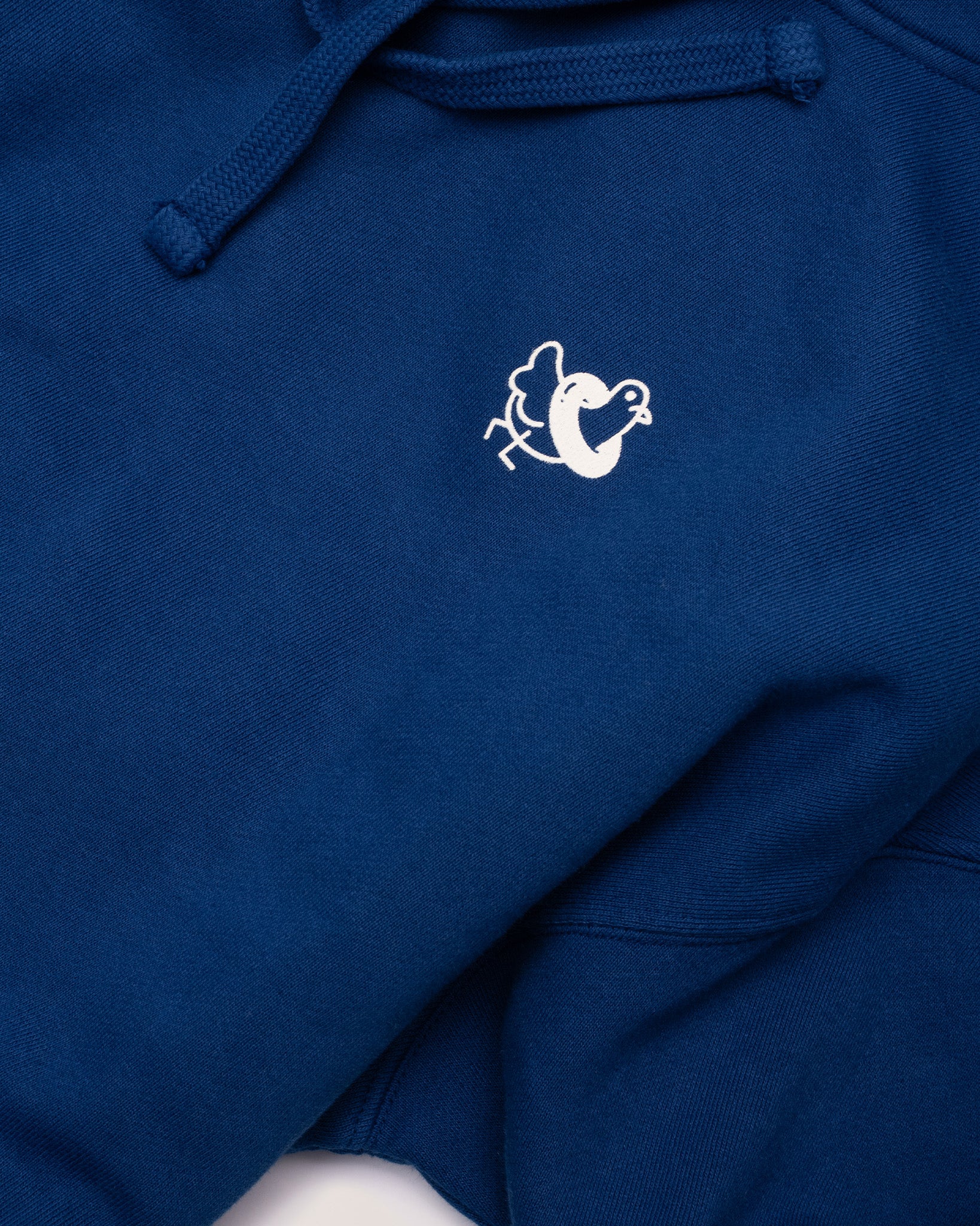 A closer image of the Public Pool icon on the front of a blue hoodie.