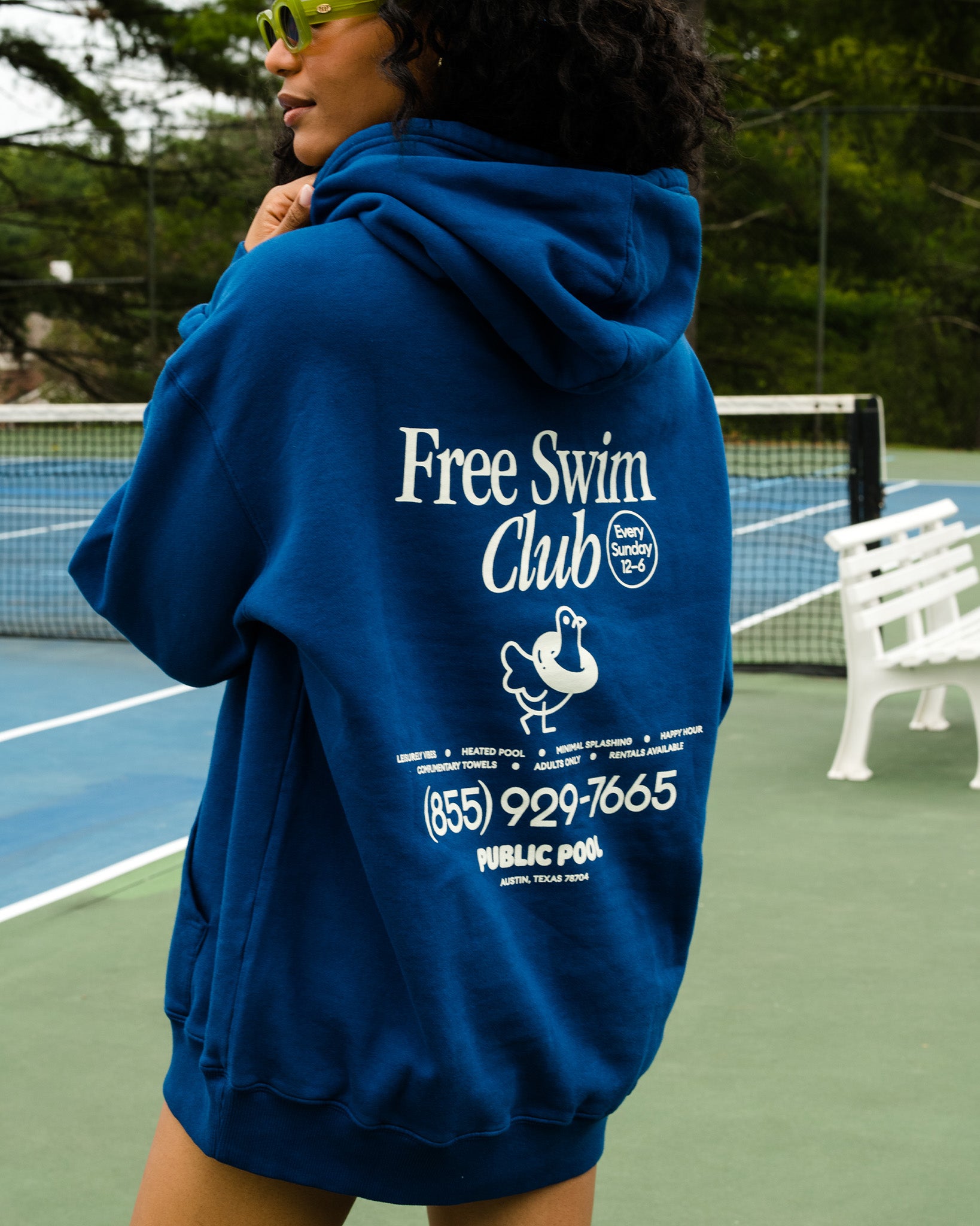 A woman wearing a blue hoodie.
