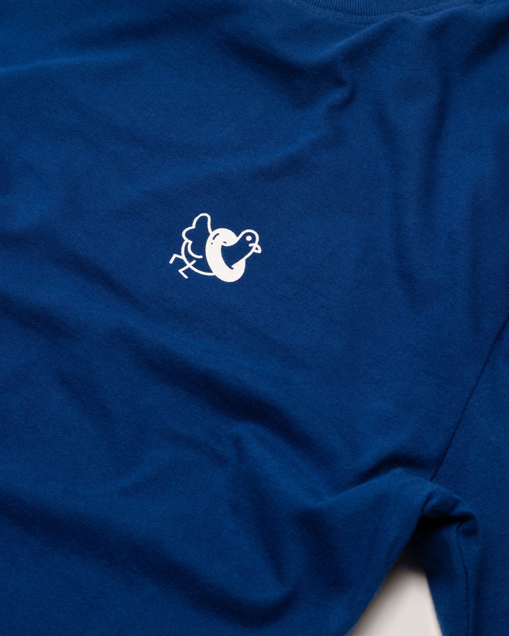 A closer image of the Public Pool icon on the front of a blue shirt. 