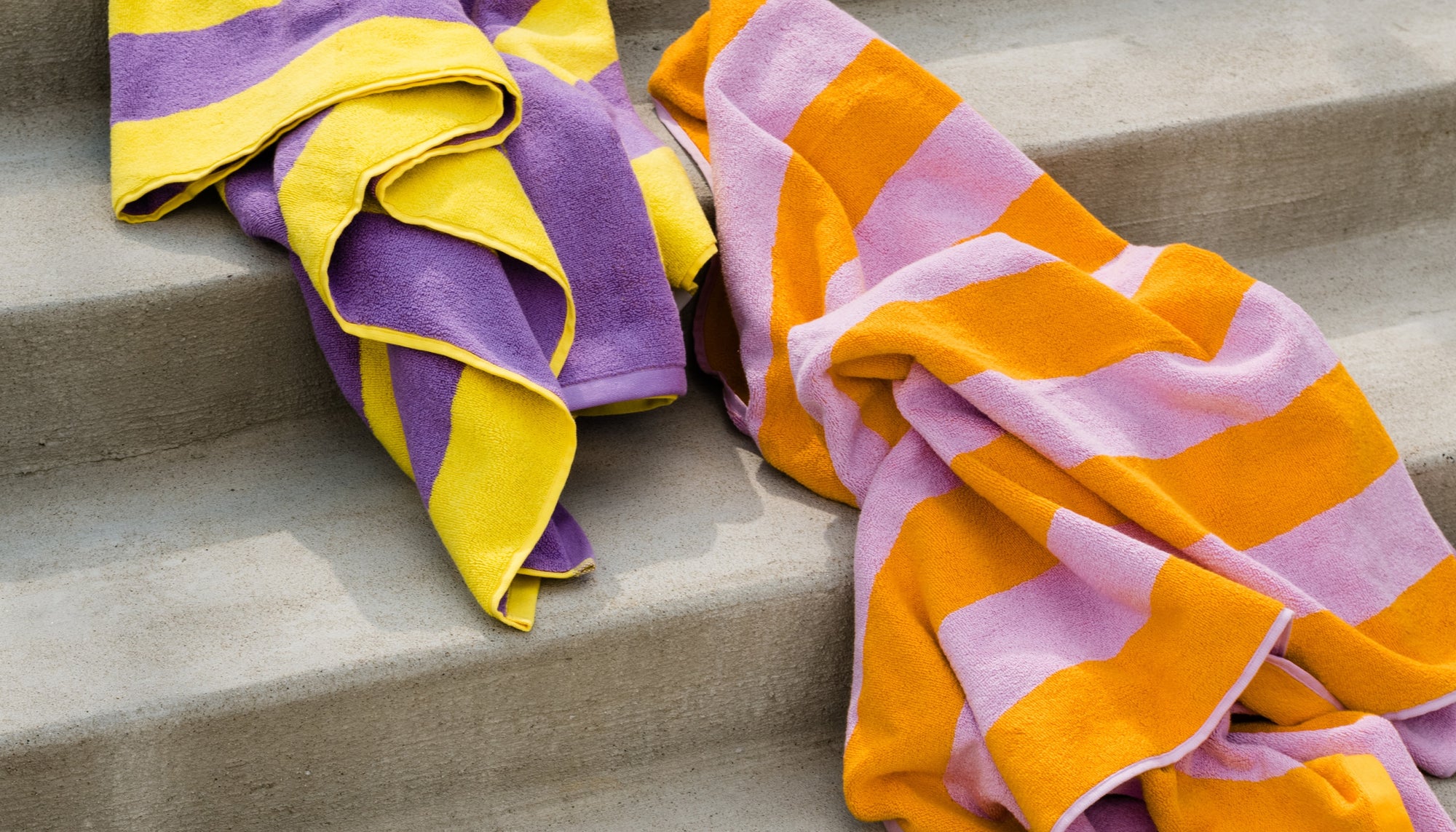 Two towels cascading down concrete stairs.