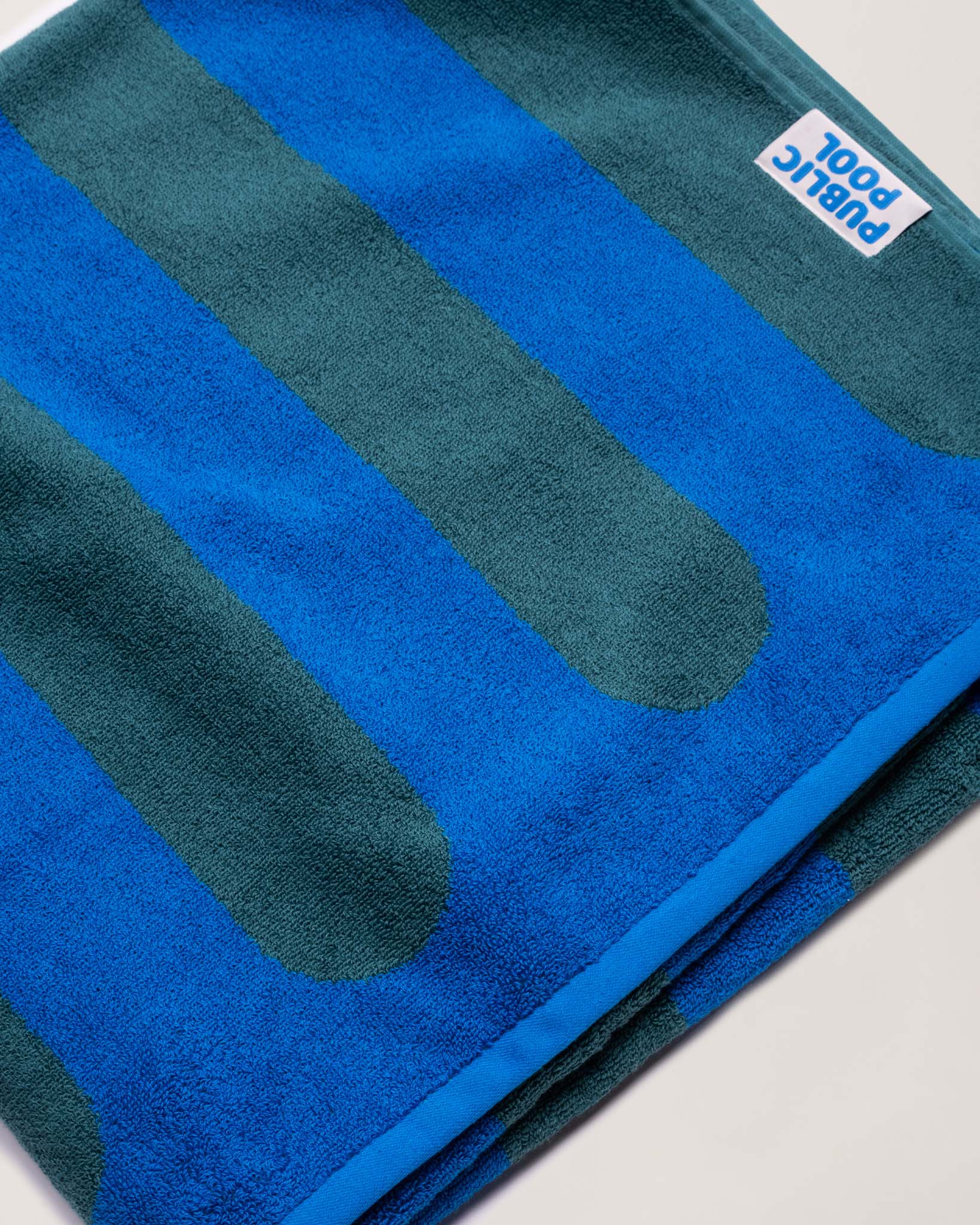 A folded blue and green striped towel. 
