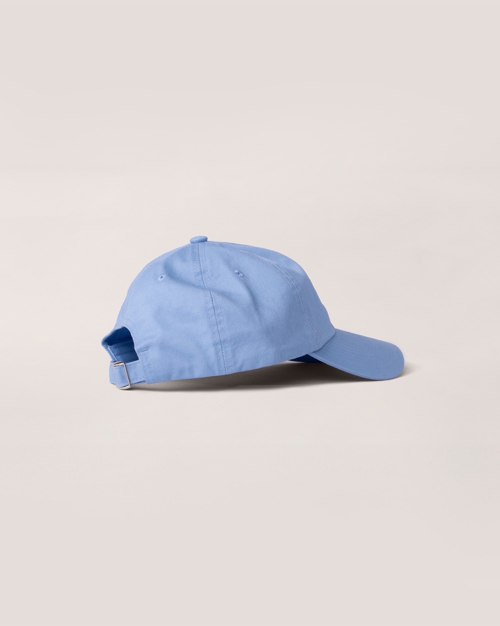 A side view of a baby blue hat. 