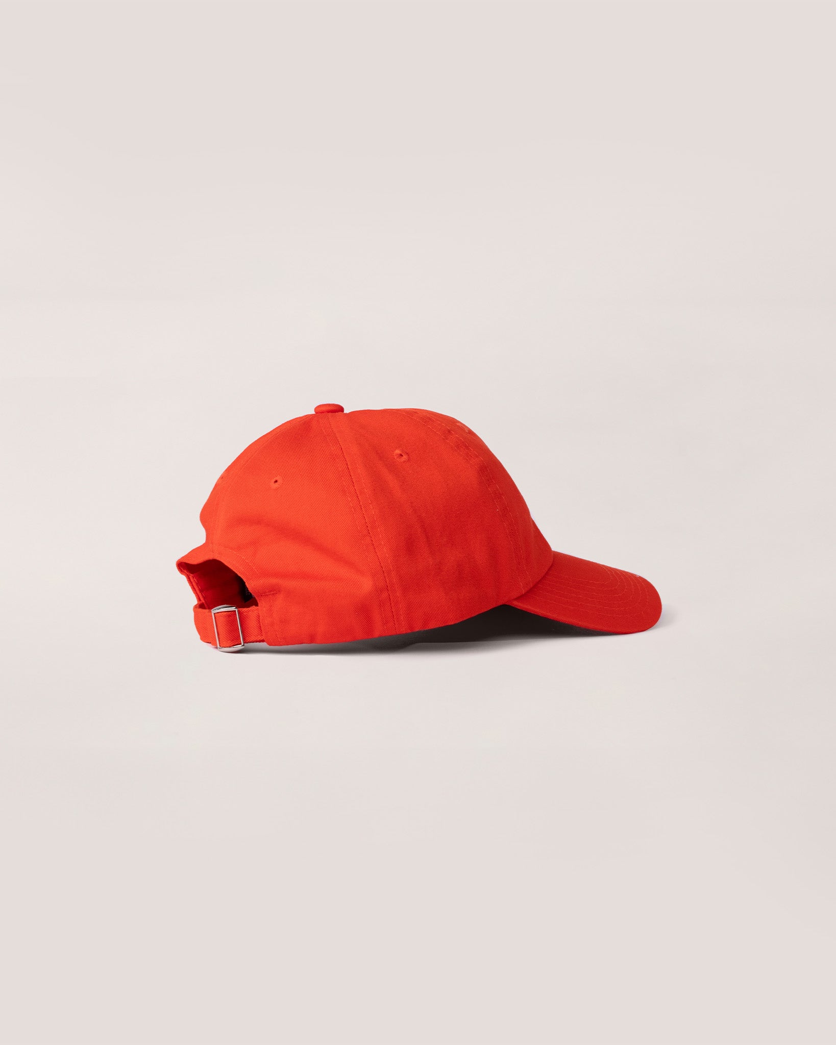 A side view of an orange hat. 