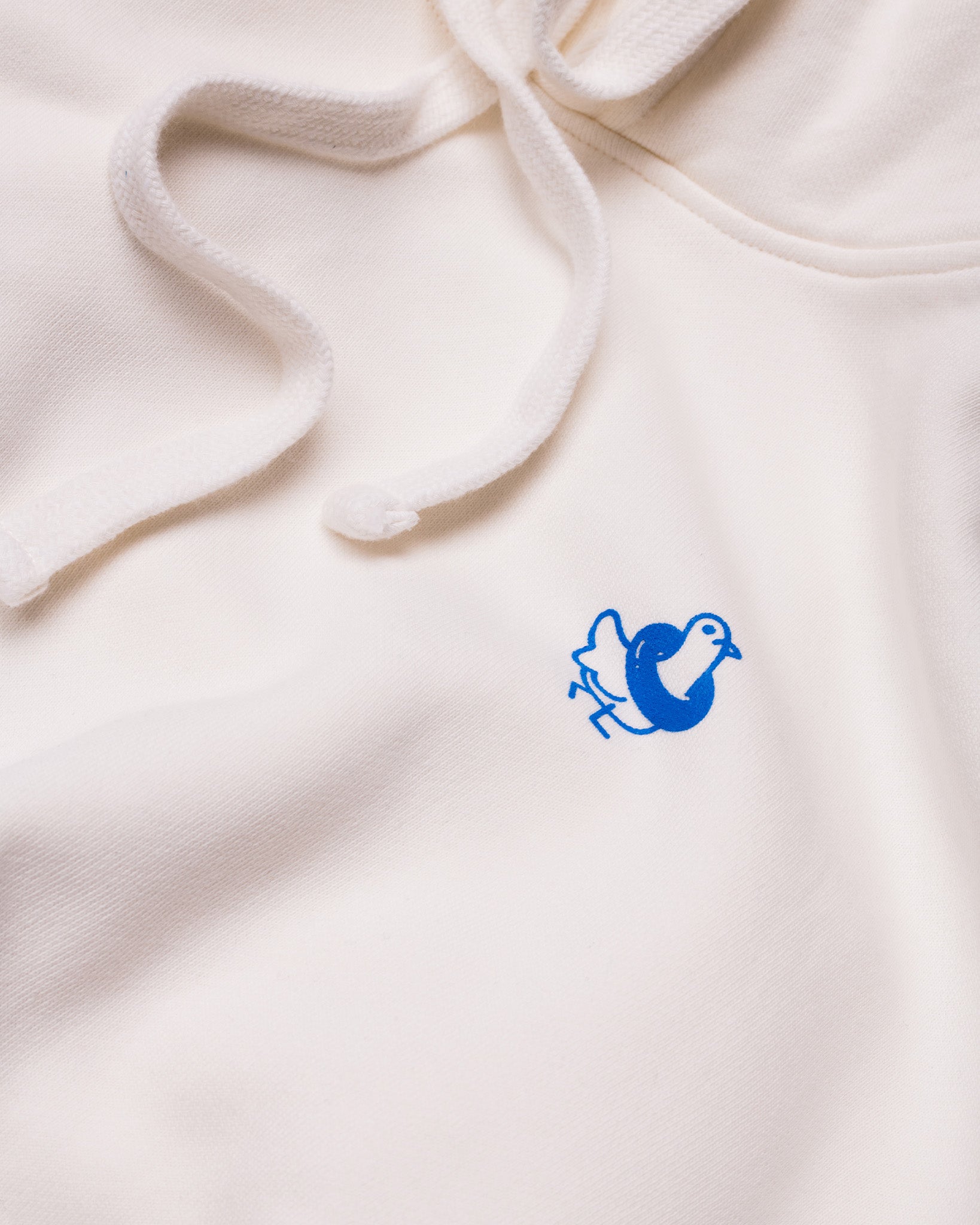 A closer image of the Public Pool icon on the front of a white hoodie. 