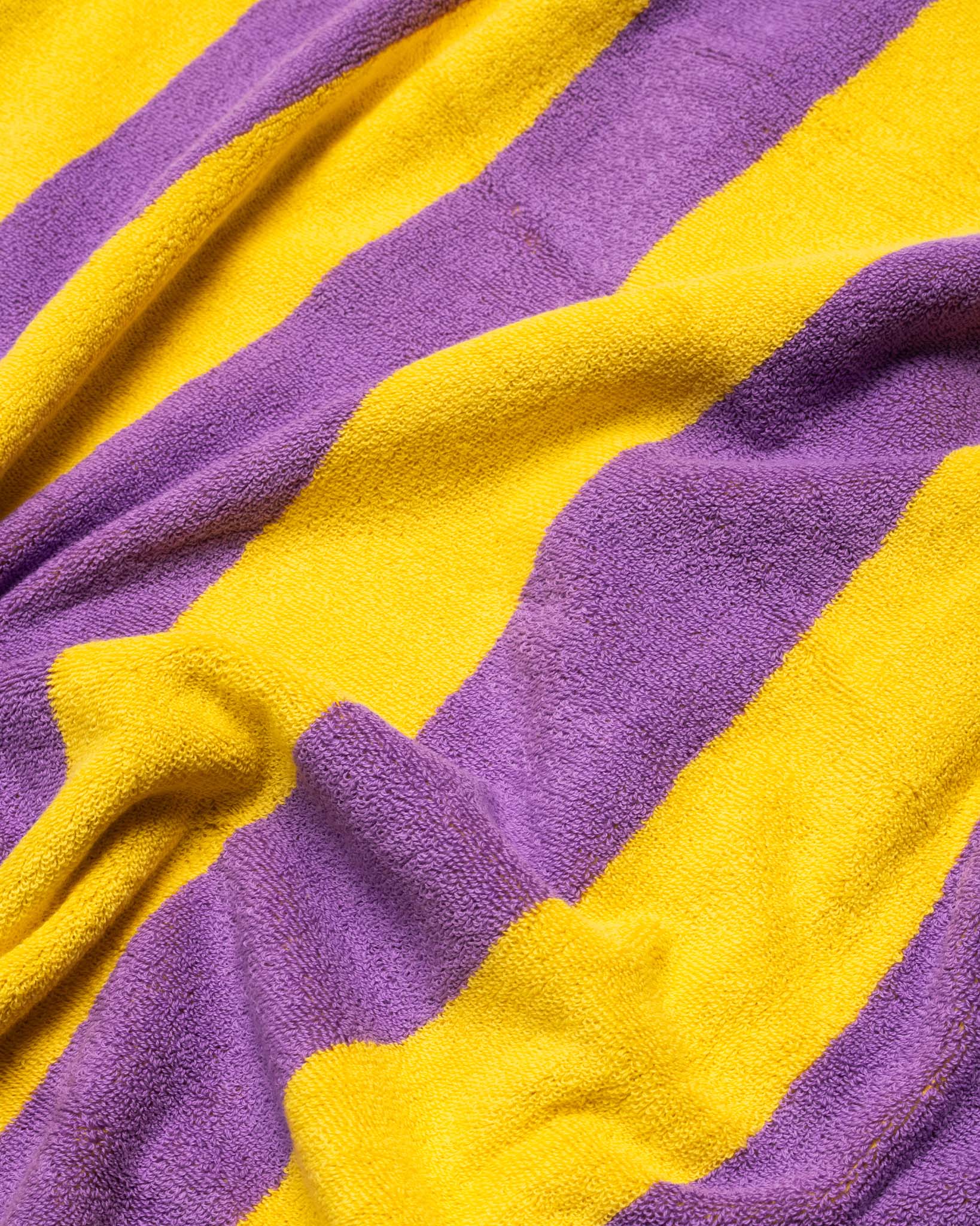 A wrinkled purple and yellow striped towel. 
