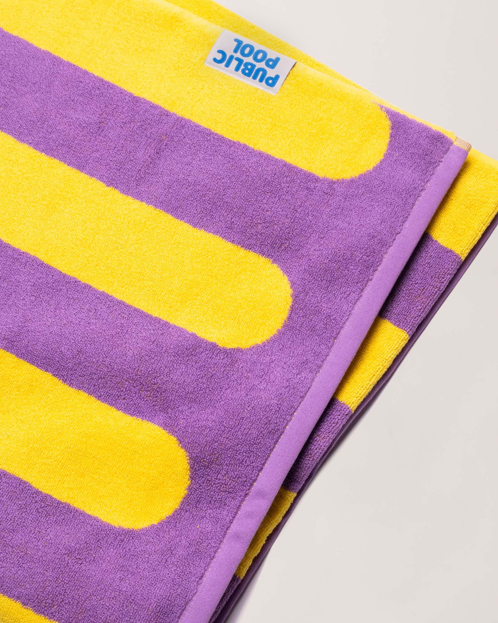 A folded purple and yellow striped towel. 