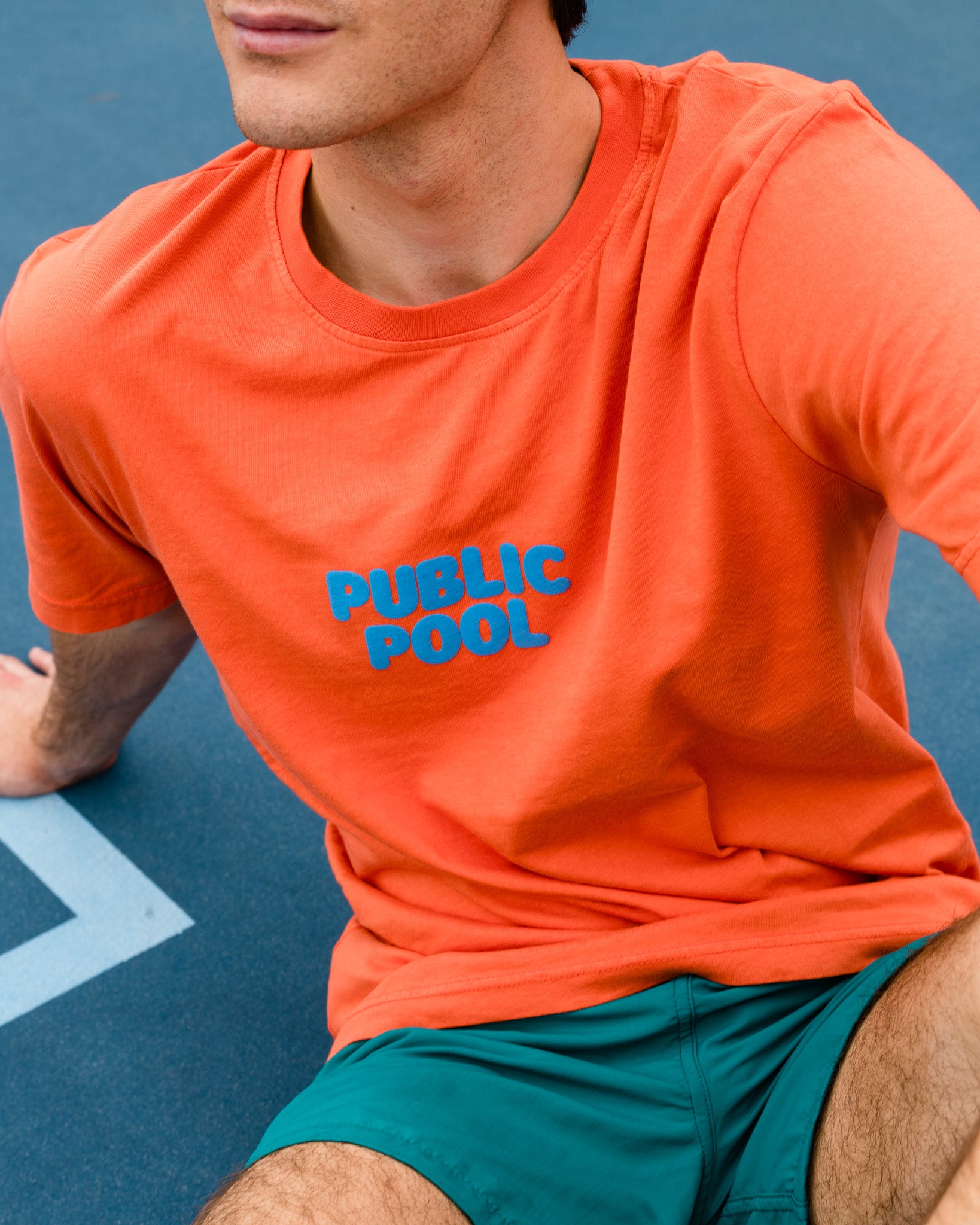 A man wearing an orange tee shirt. 