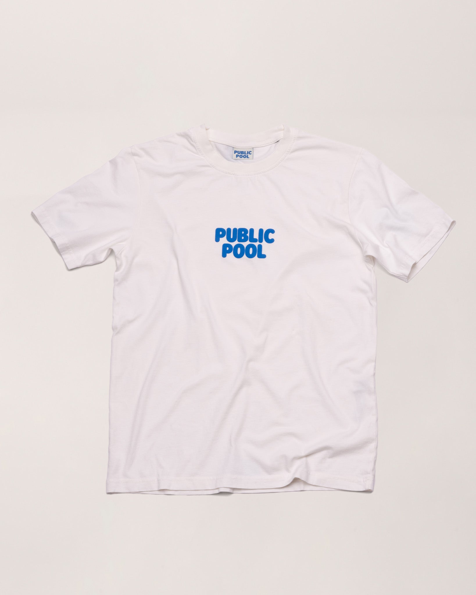 A white tee shirt with a blue Public Pool logo. 