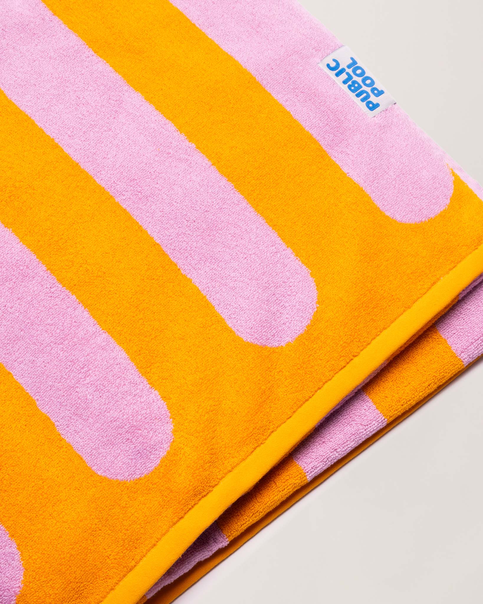 A folded pink and orange striped towel. 