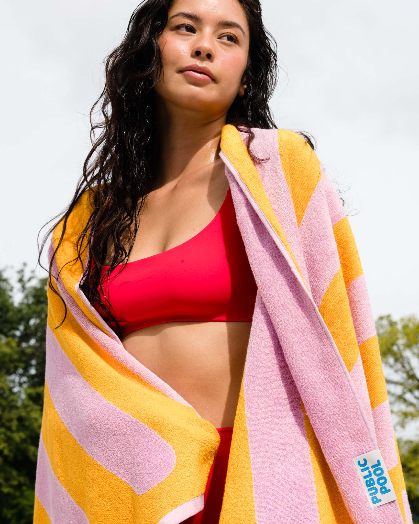 A woman drying off with a towel. 