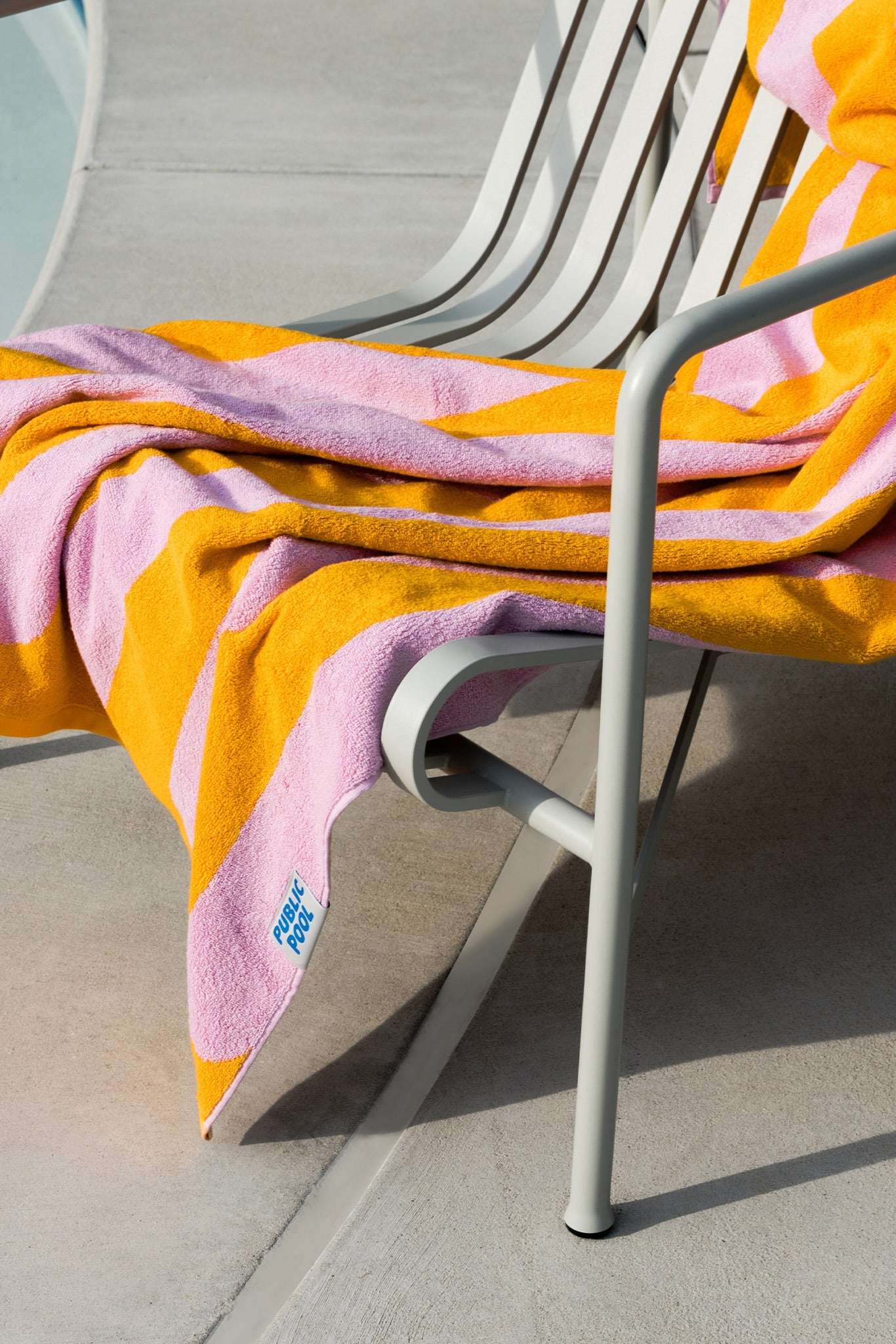 A towel draped over a patio chair. 