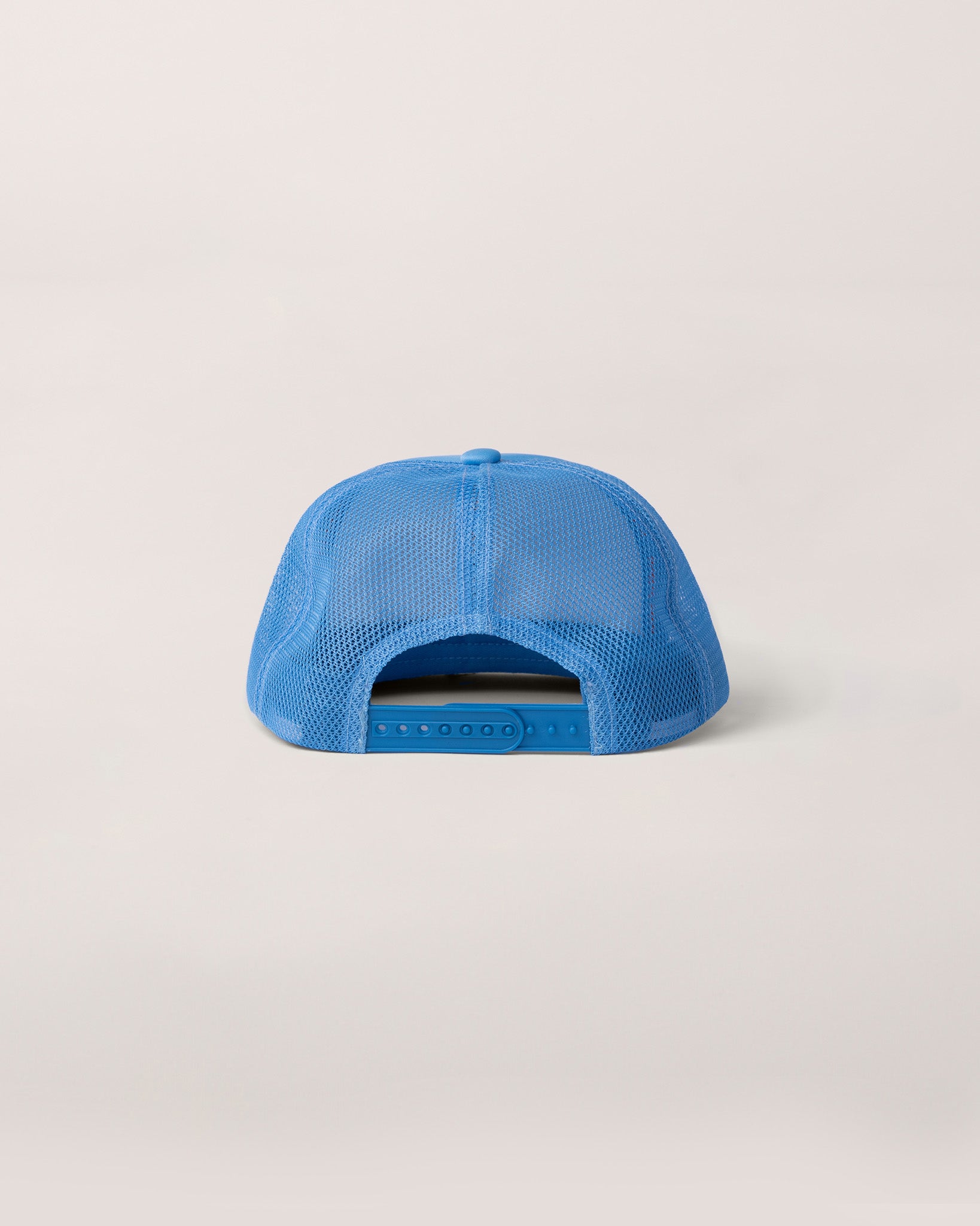 A view of the back of a baby blue trucker hat. 