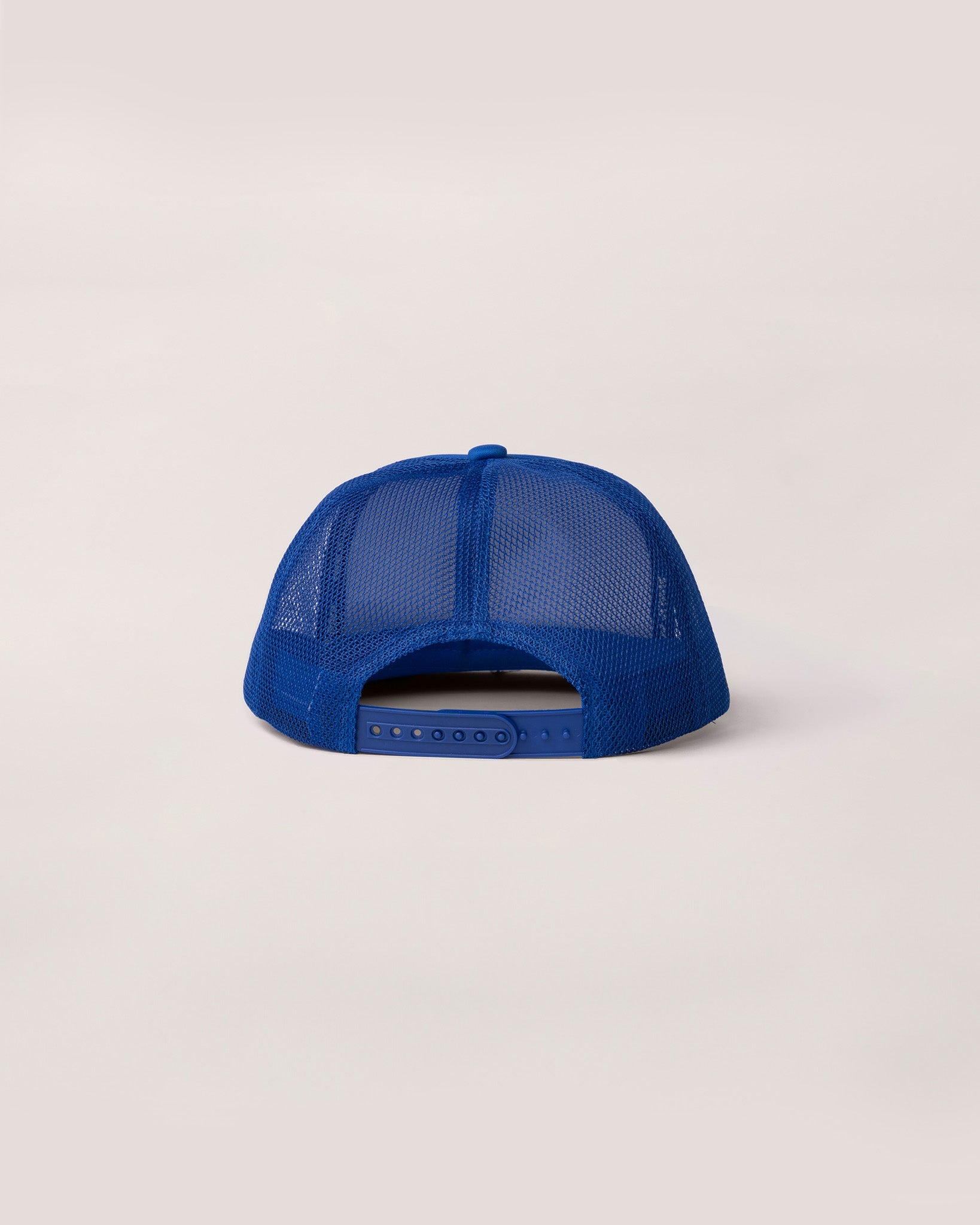 A view of the back of a blue trucker hat. 